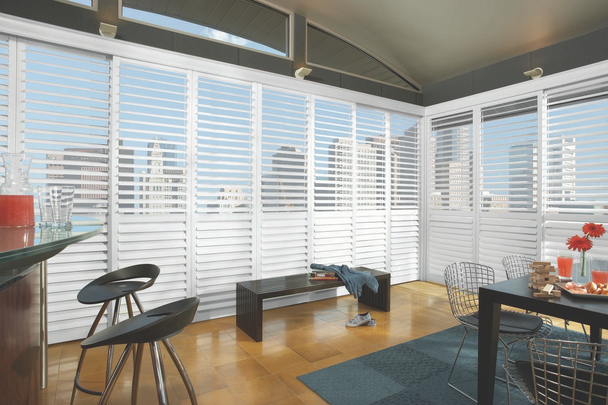 Dining room window treatments for homes near Venice, Florida (FL) including custom motorized shutters.