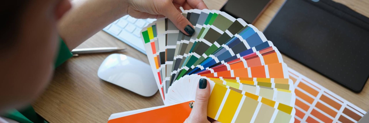 A female designer holding color samples for an interior design consultation near Venice, FL